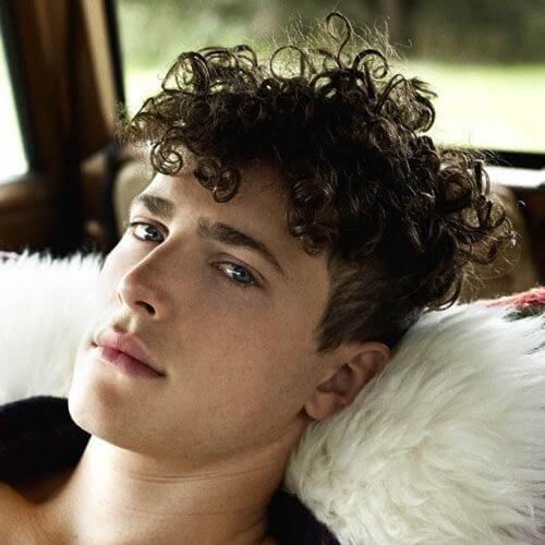 messy curls haircut for teenage guys