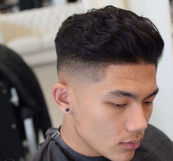 brushed back wavy hairstyle for guys