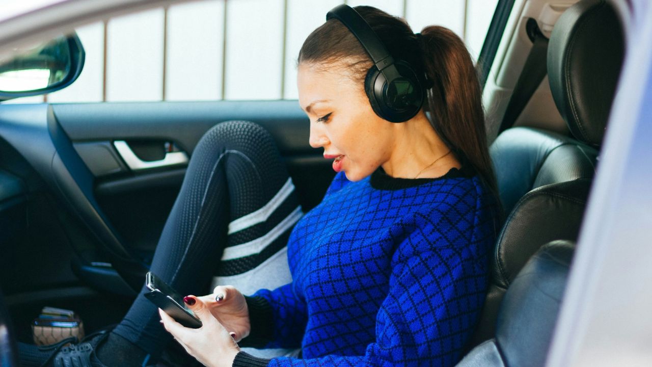 Wearing headphones over both ears while driving
