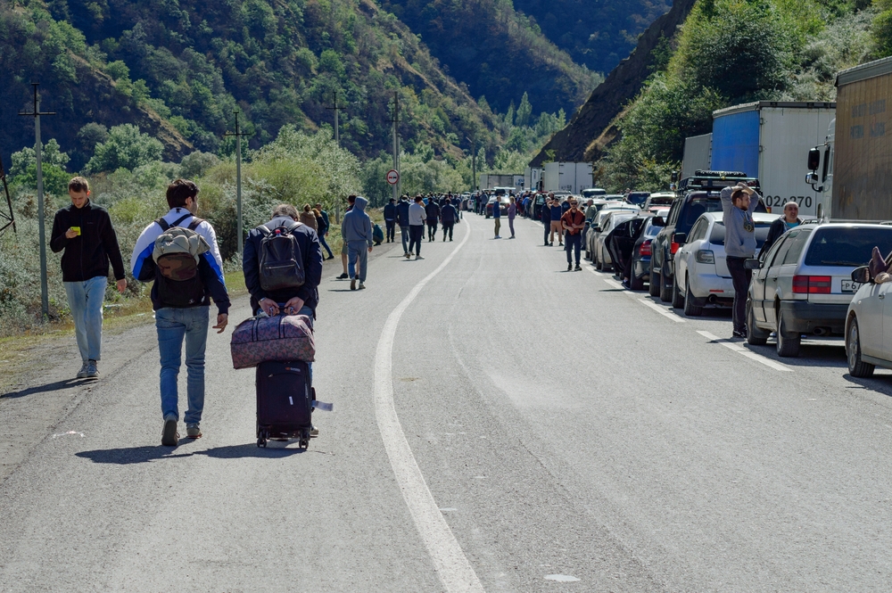 Lars, Russia - September, 26, 2022: Mobilization in Russia, Russian-Georgian border, traffic jam and queue of people fleeing abroad, asphalt road and green mountain slopes around